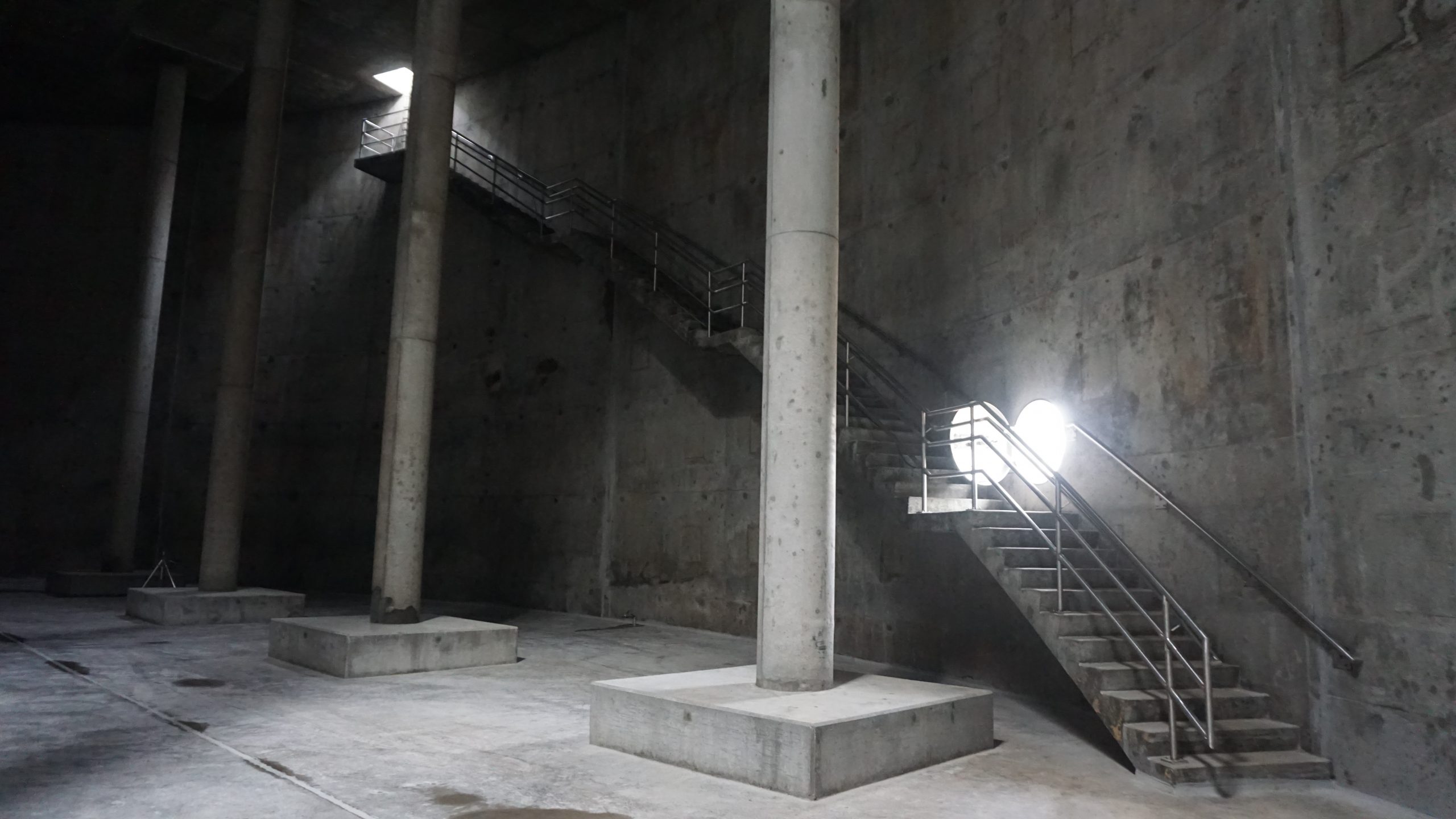 Large concrete columns and stairs inside Flat Iron Tank