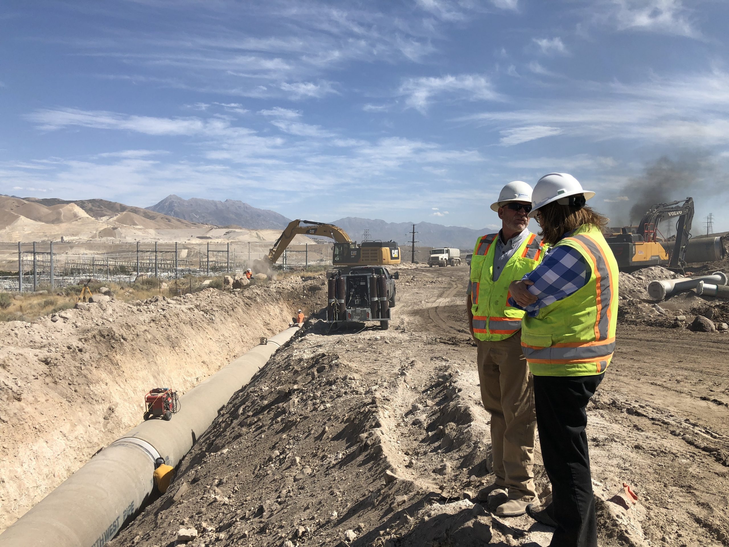 Two construction workers conversing on site of Southwest Aqueduct Reach 1 project.