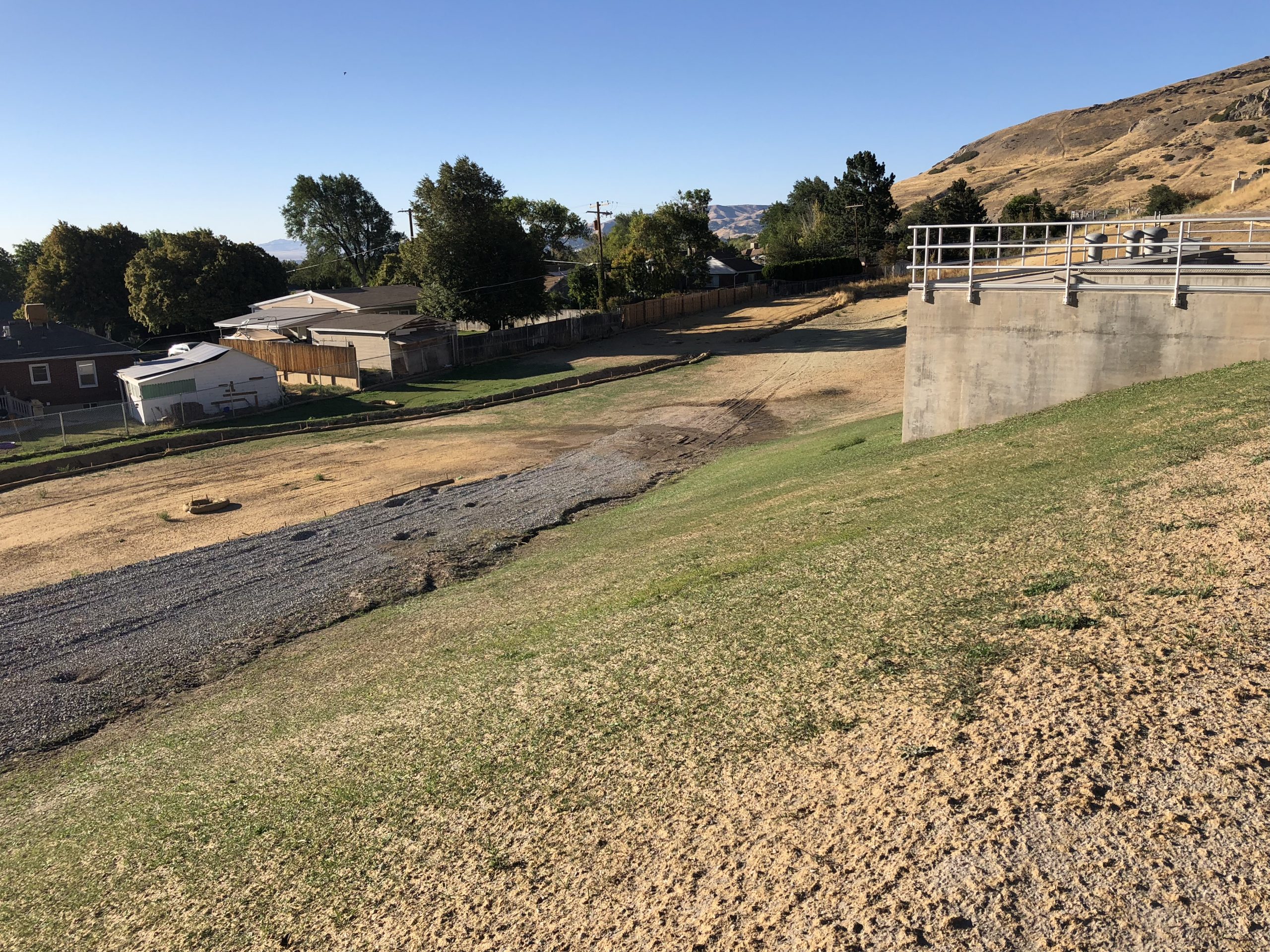 View of Terminal Reservoir Project in Salt Lake & Sandy Districts with adjacent neighborhood homes in the background.