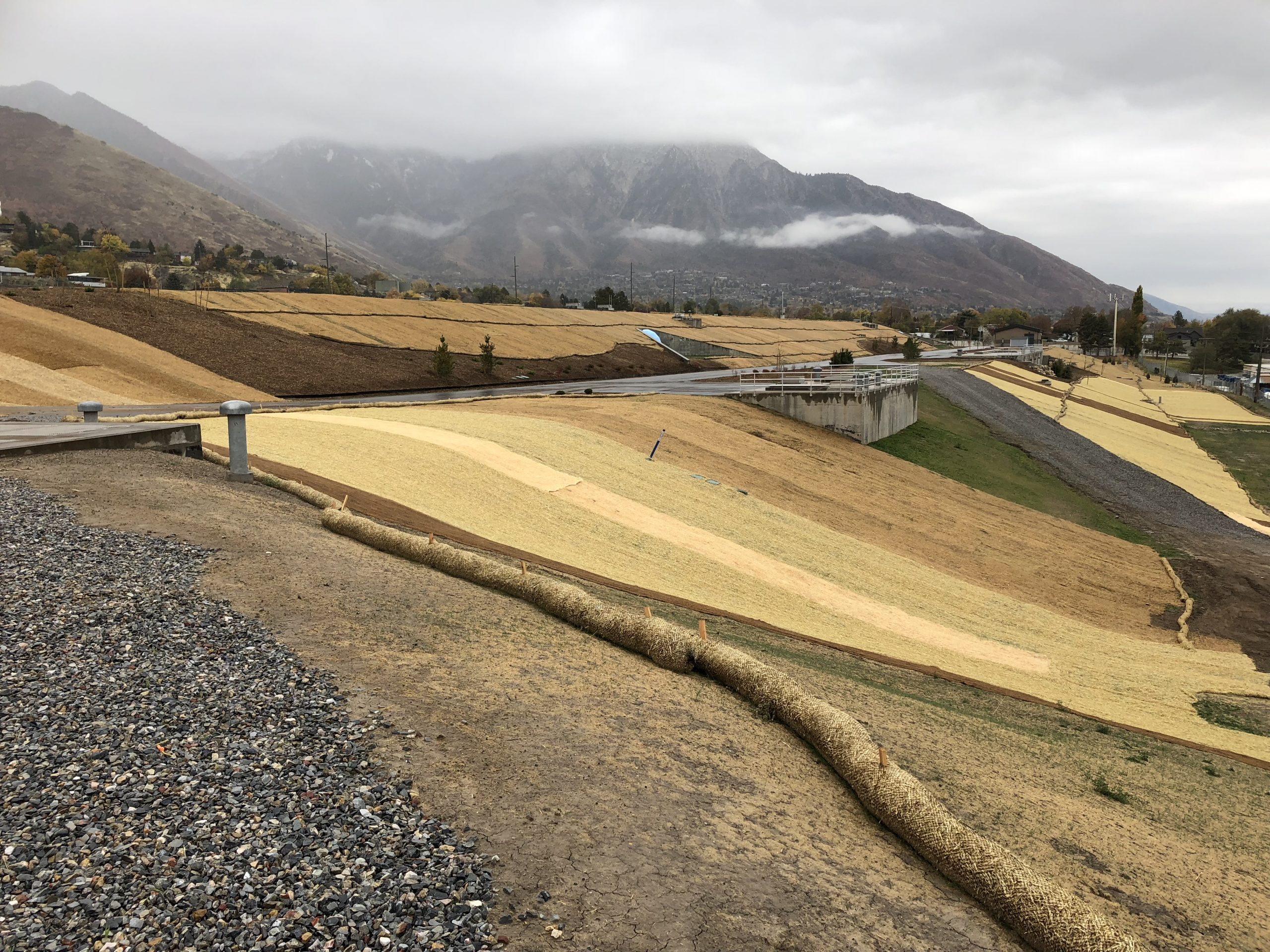 View of Terminal Reservoir Project in Salt Lake & Sandy Districts with cloudy mountains in the background