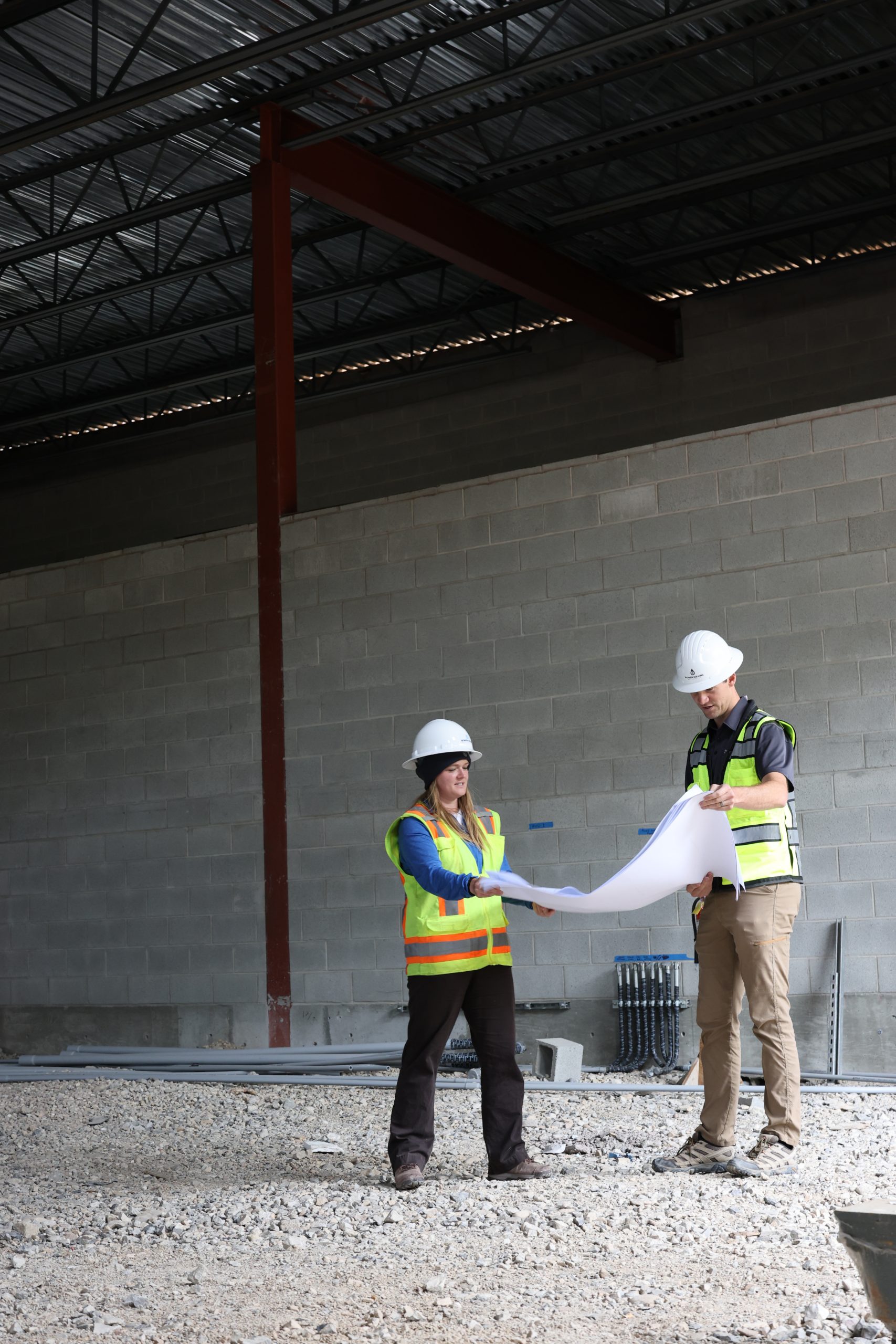 Construction workers discussing blueprints